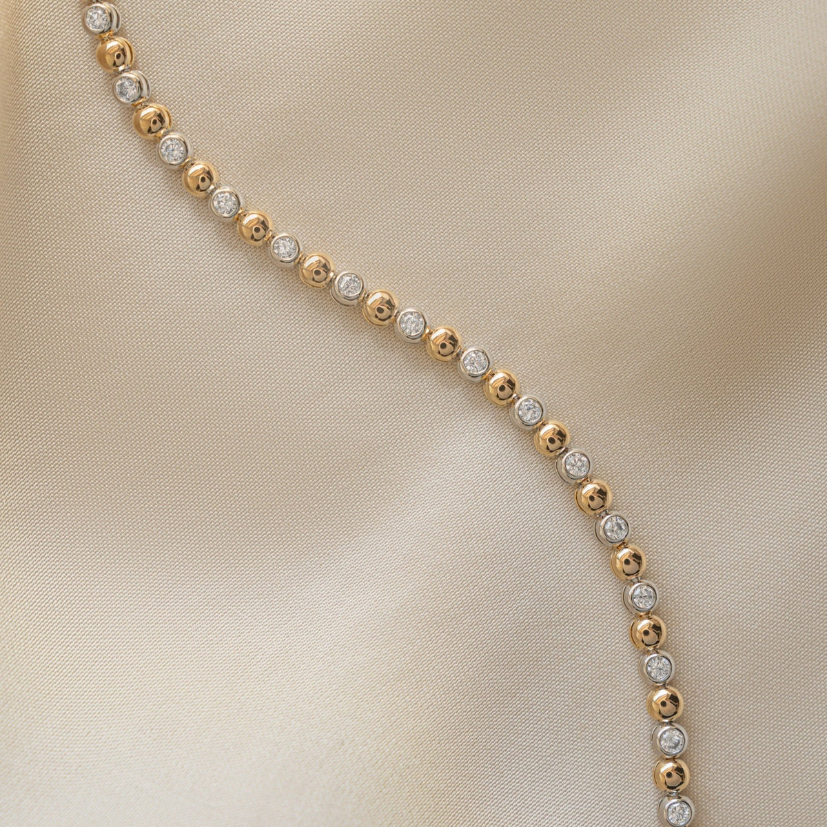 Bracelet tennis bicolore à perles et sertis clos