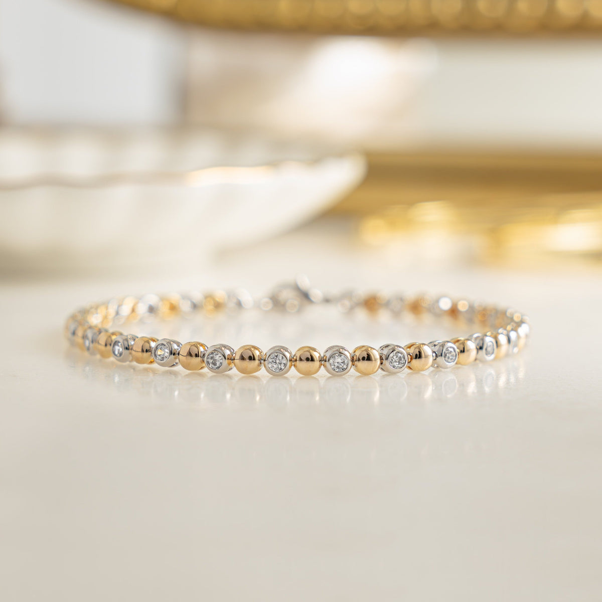 Bracelet tennis bicolore à perles et sertis clos