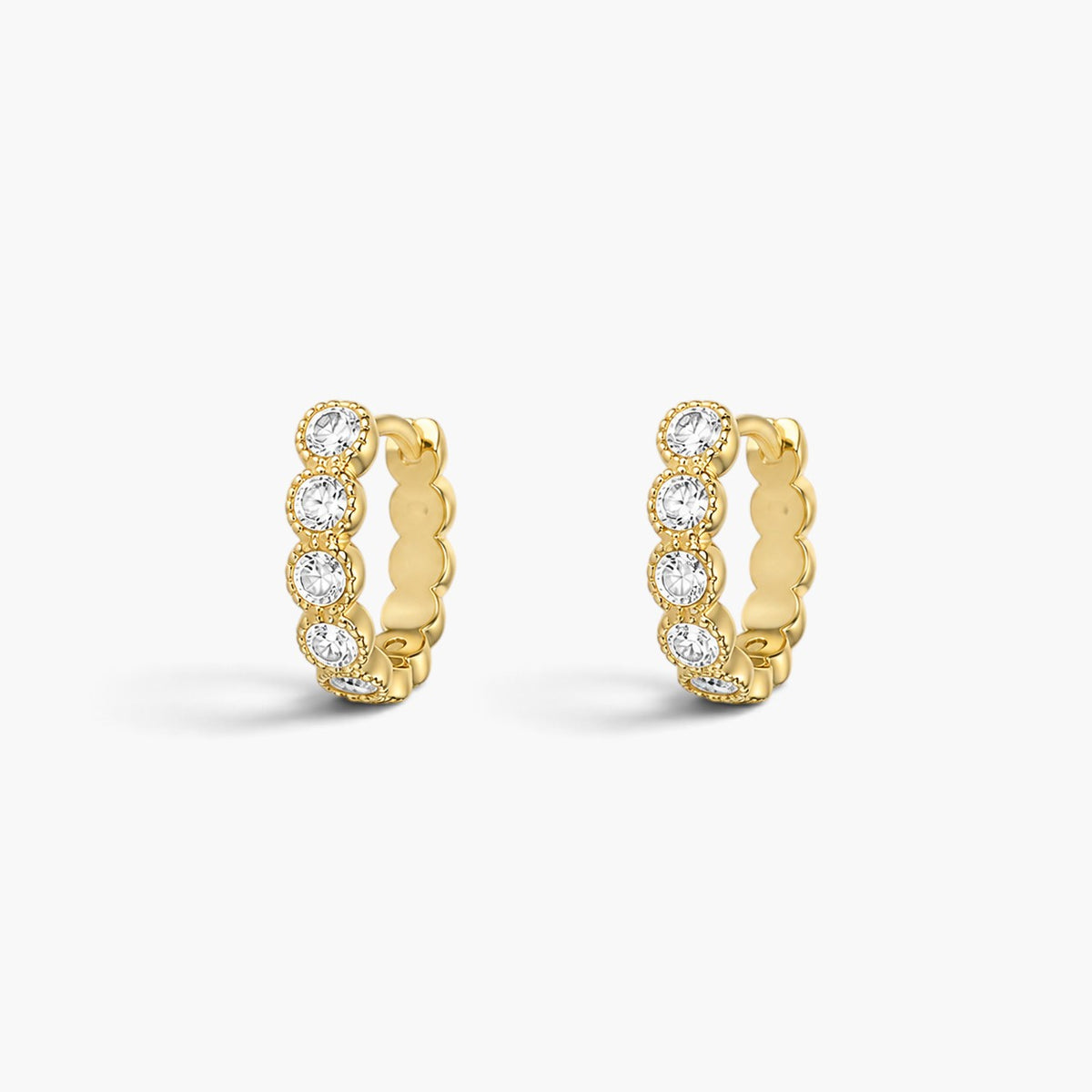 Evervanta Thea huggie hoop earrings in 18K gold plated finish with delicate clear stone accents