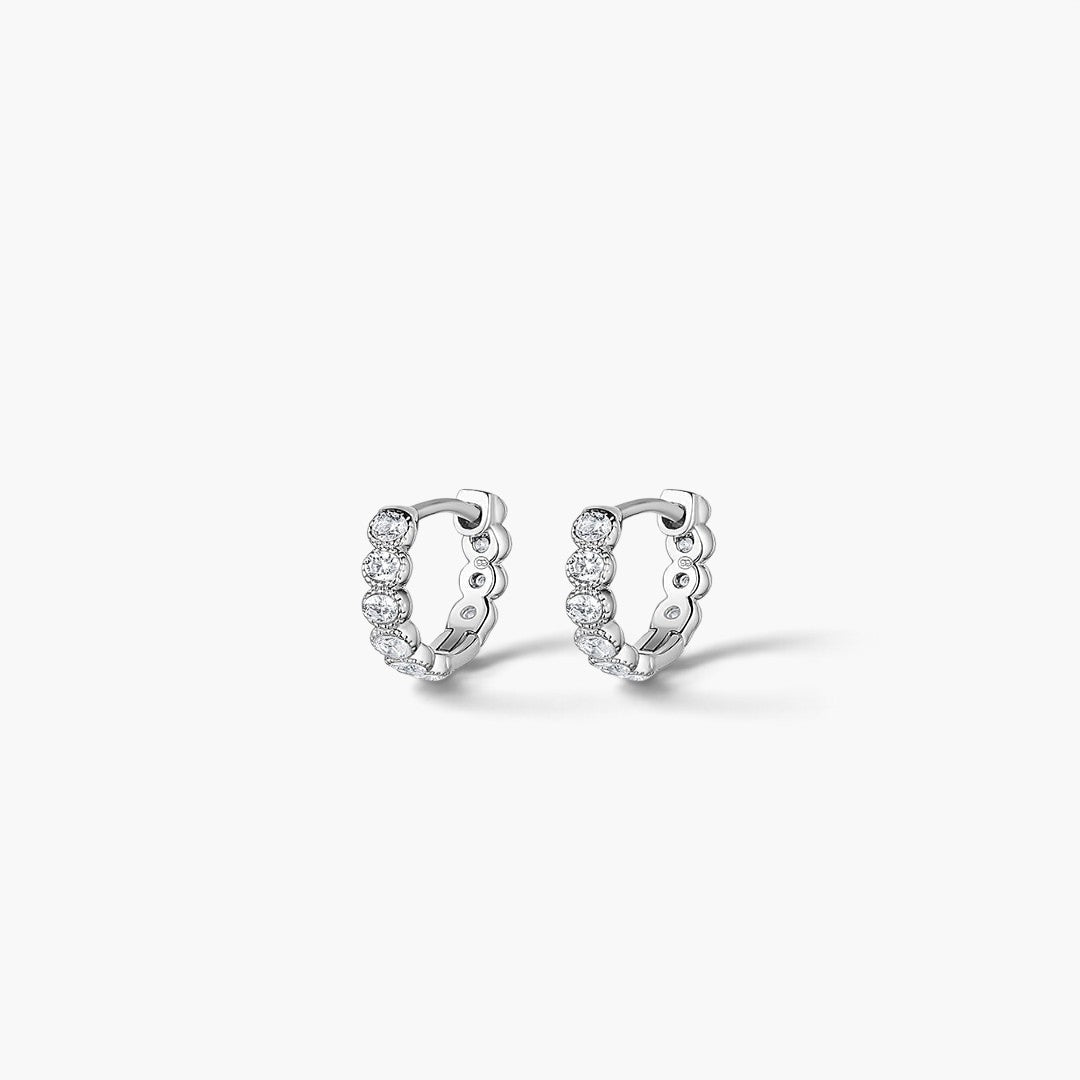 Evervanta Thea silver-plated huggie hoop earrings featuring a row of sparkling round stones for everyday elegance.